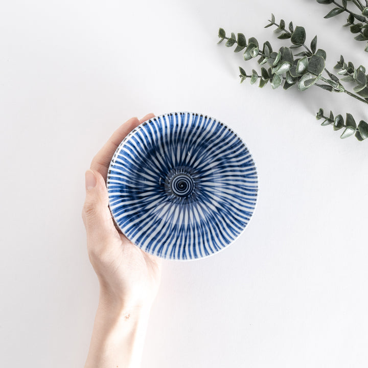 Top-down view of the rice bowl showing its flared shape and intricate blue stripes radiating from the center.