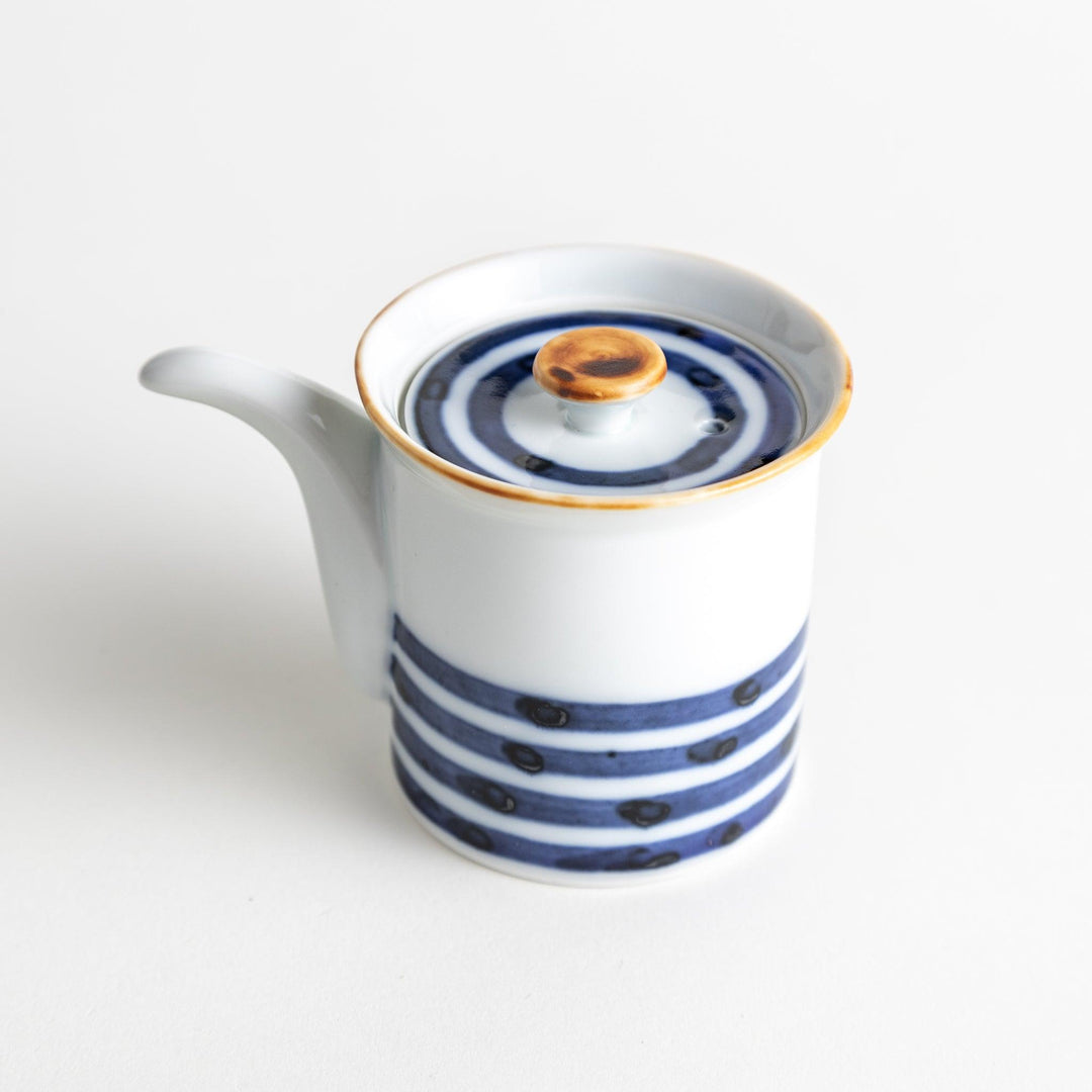 A small white ceramic soy sauce dispenser featuring blue horizontal stripes.