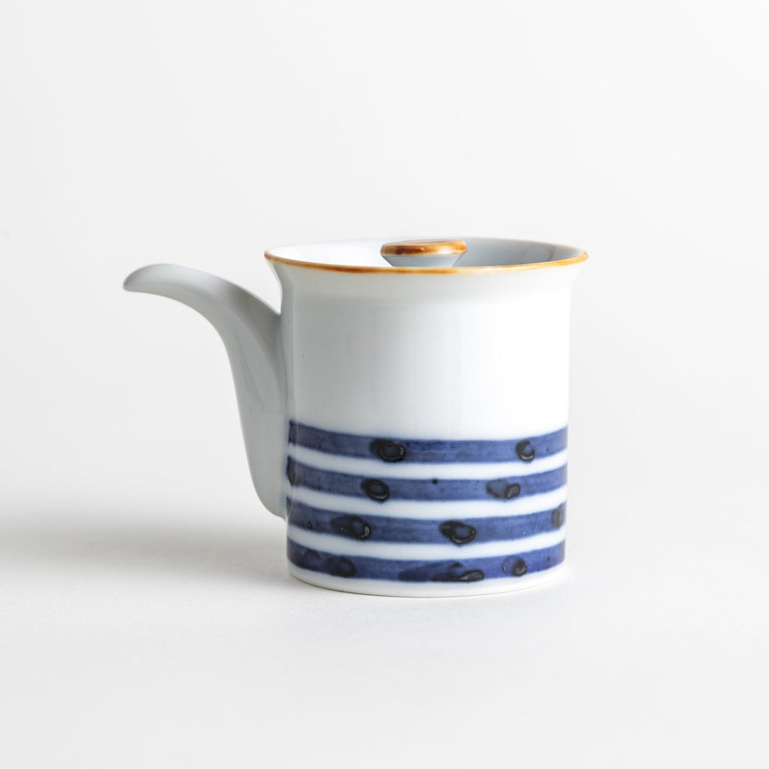 A small white ceramic soy sauce dispenser featuring blue horizontal stripes.