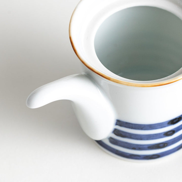 A small white ceramic soy sauce dispenser featuring blue horizontal stripes.