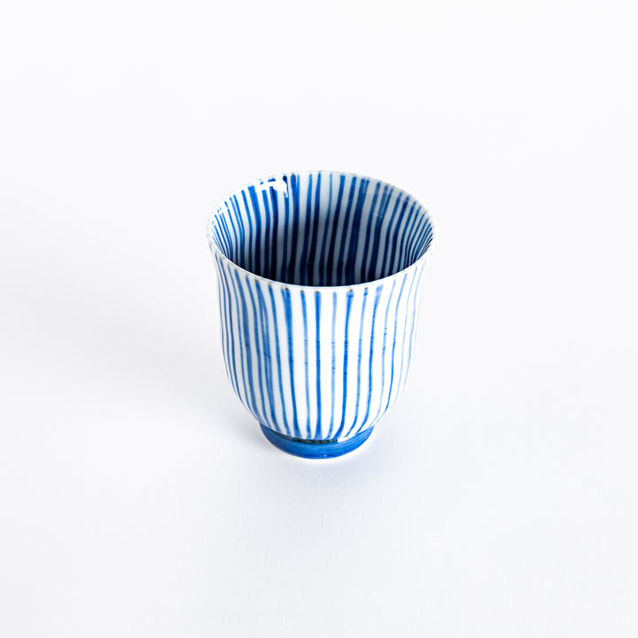 Slightly angled view of the blue-striped tea cup, highlighting its elegant shape and vertical stripe pattern.