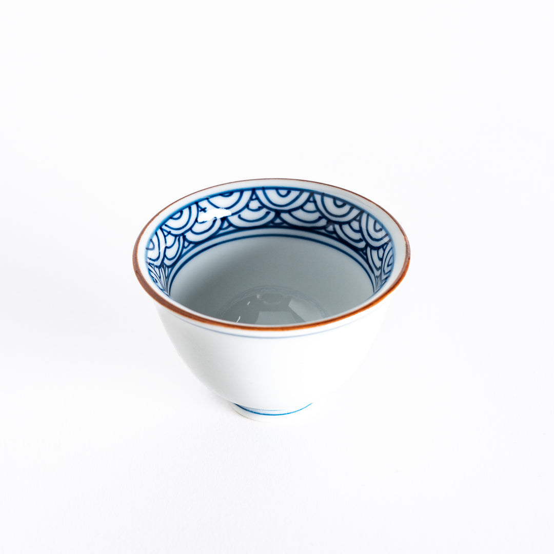 Top-down view of the sake cup showing the detailed blue wave design on the inner rim and smooth white porcelain.