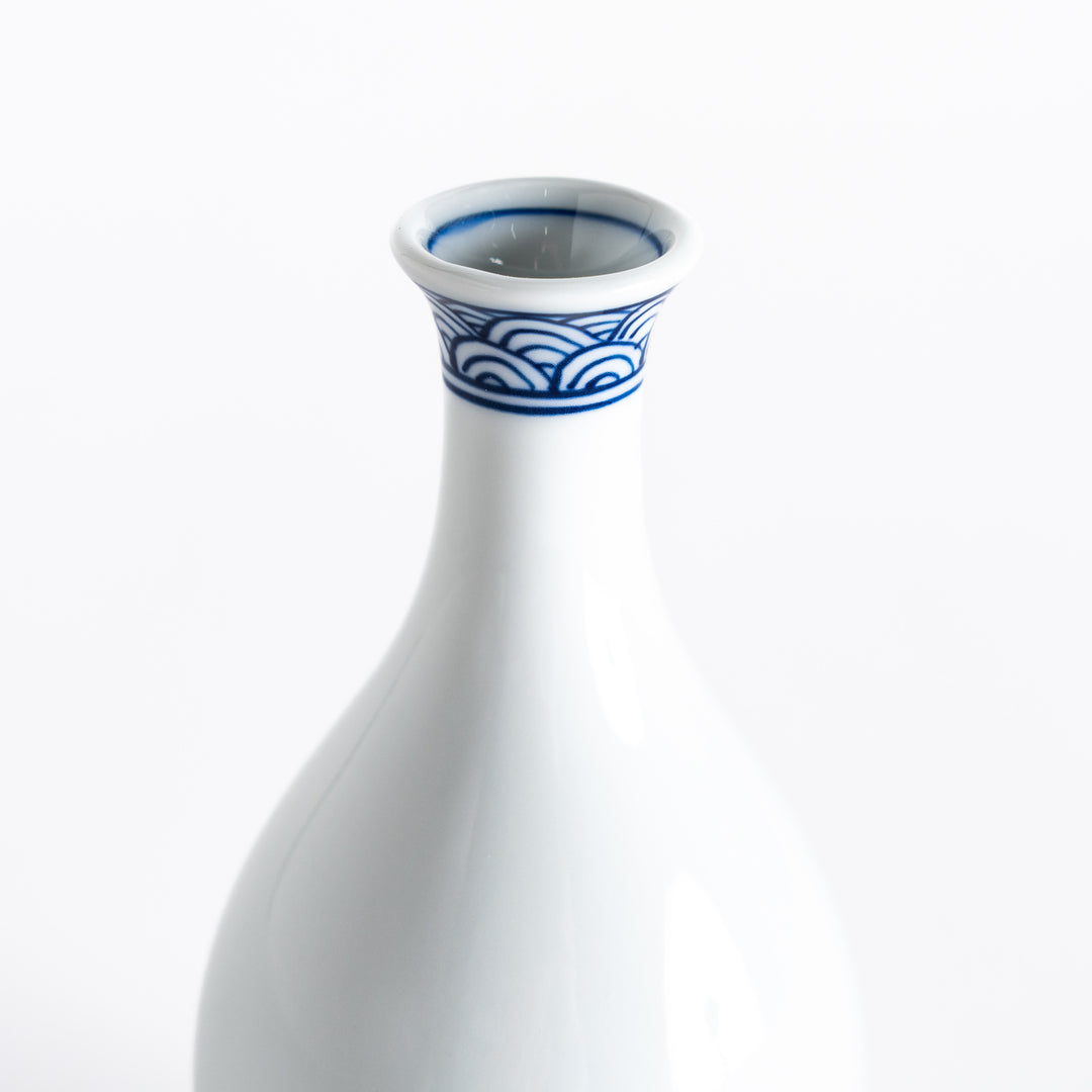 Close-up of the sake flask's blue wave pattern and smooth white porcelain surface.