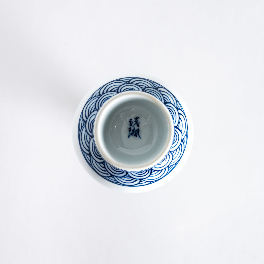 Bottom view of the sake flask highlighting the blue wave motif at the base and its unglazed bottom.