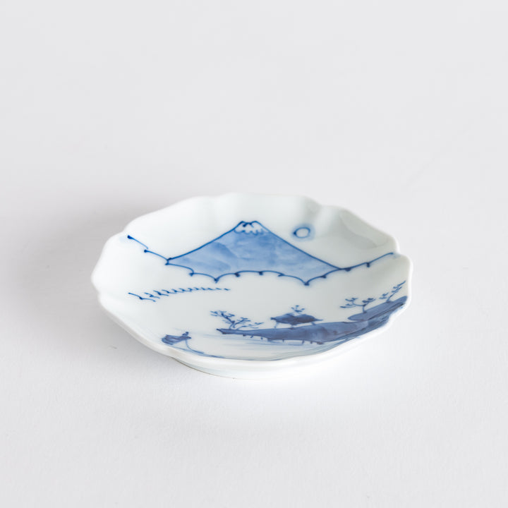 Top-down view of the blue and white sauce dish displaying a serene mountain landscape surrounded by delicate flowers.