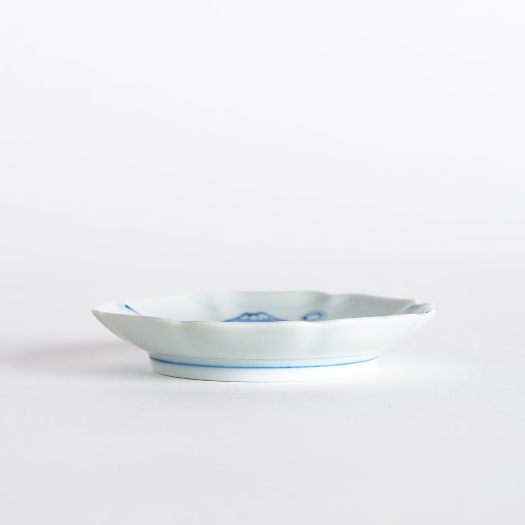 Side view of the rimmed sauce dish, illustrating its elegant shape and beautiful blue floral designs.