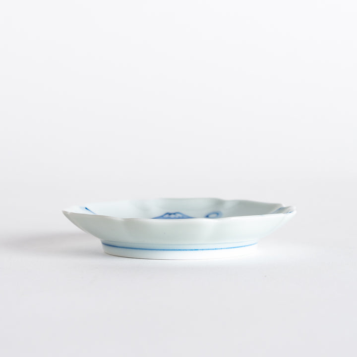 Side view of the rimmed sauce dish, illustrating its elegant shape and beautiful blue floral designs.