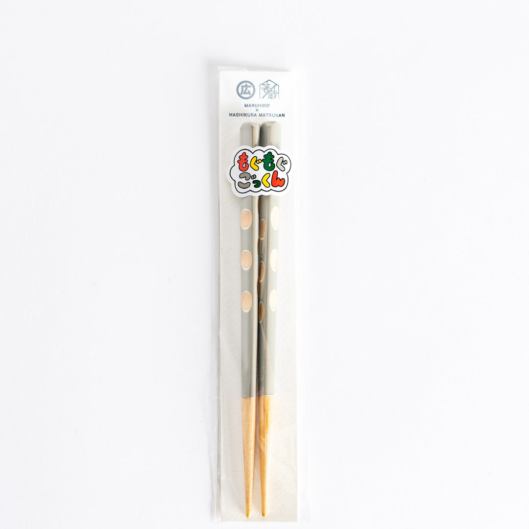  Gray chopsticks with polka dots, displayed in a plastic packaging with a colorful label.