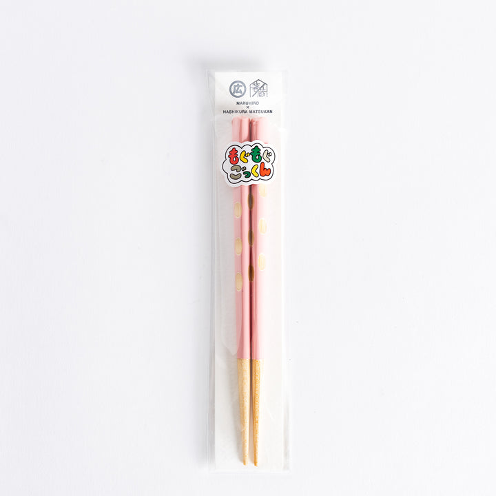 Pink children’s chopsticks with wood tips, packaged in a transparent bag.