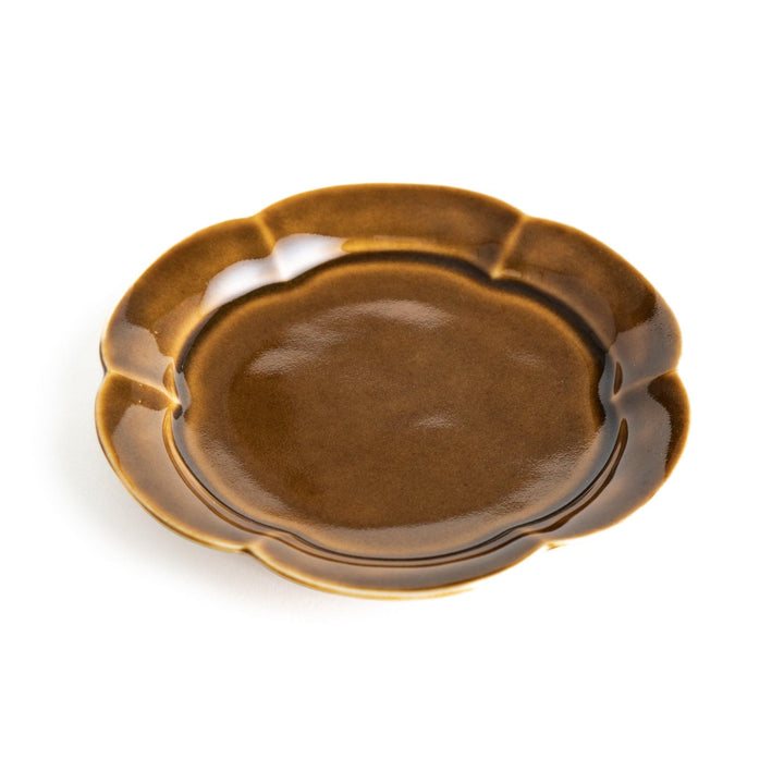 Small flower-shaped sauce dish in green, brown, and white.