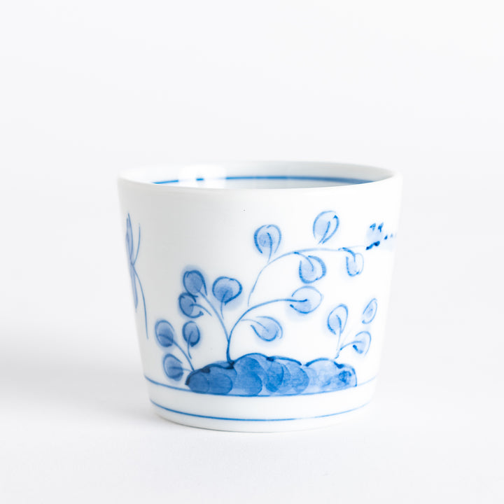 A white condiment bowl decorated with blue bush clover patterns around the side, ideal for small servings or sauces.