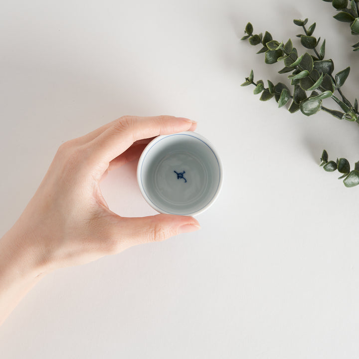 A white condiment bowl decorated with blue bush clover patterns around the side, ideal for small servings or sauces.