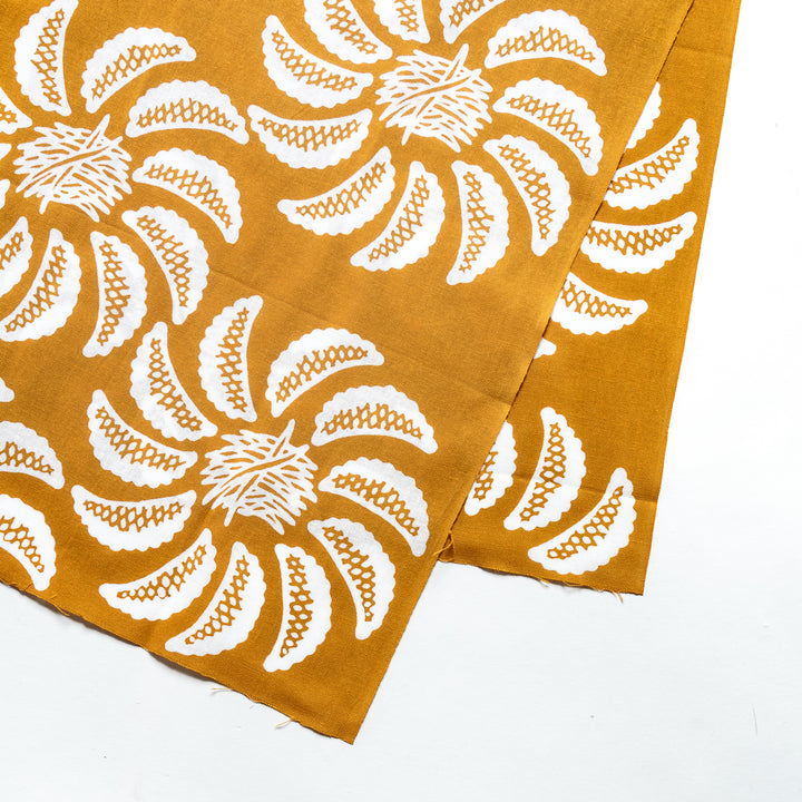 Close-up of the white gyoza patterns on the mustard yellow tenugui.