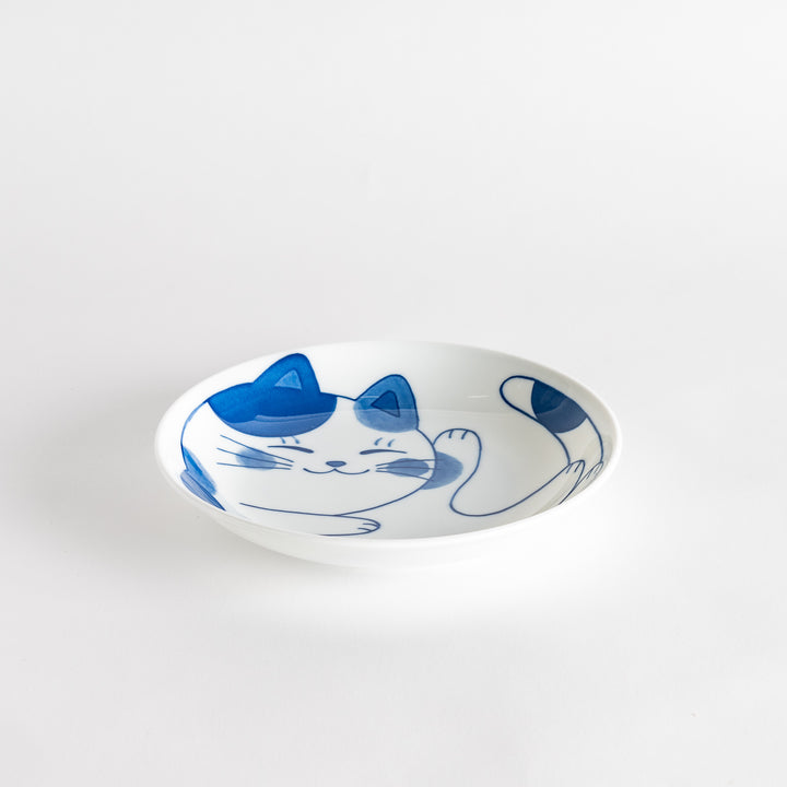 A cereal bowl with a cheerful blue and white cat, playfully kicking its leg up.