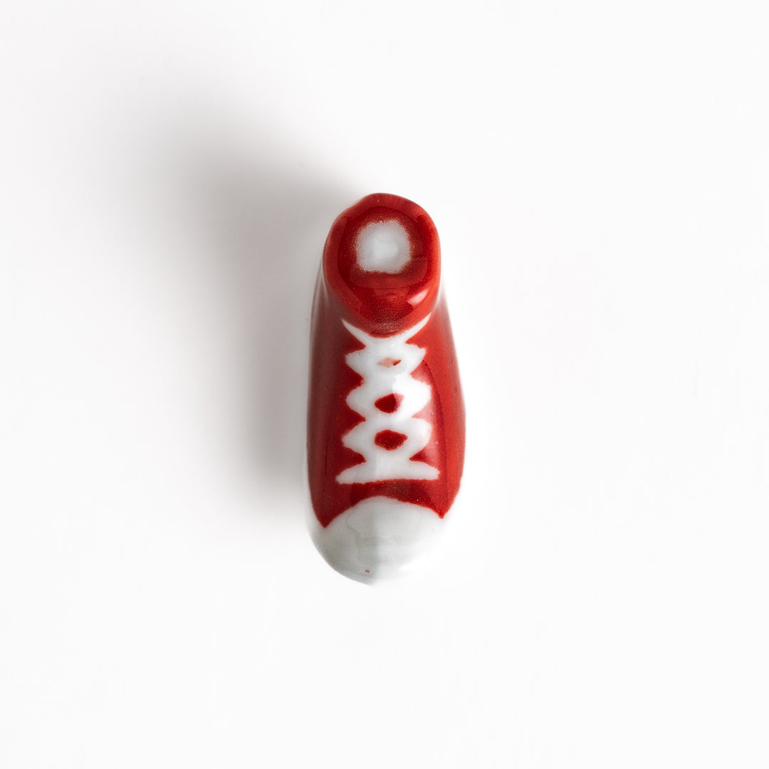 Red Canvas Sneaker Chopstick Rest with white laces and a detailed high-top design, adding a playful touch to your table setting.