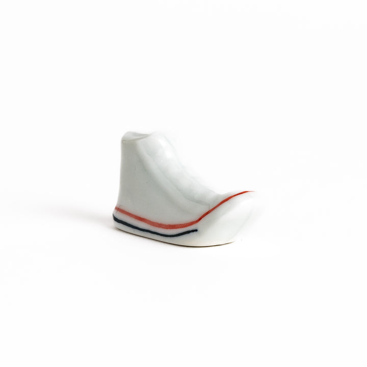 White Canvas Sneaker Chopstick Rest with white laces and a detailed high-top design, adding a playful touch to your table setting.