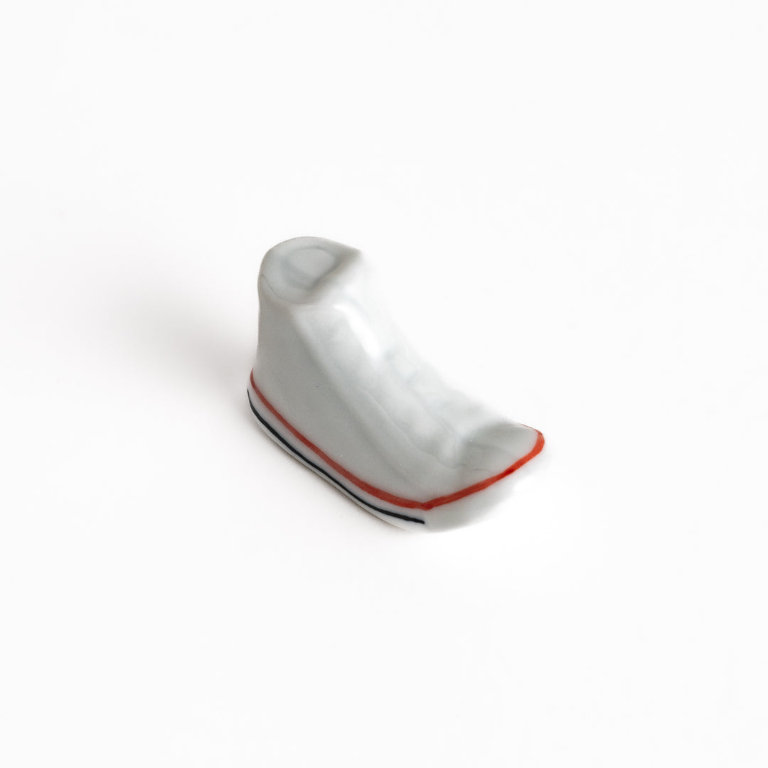 White Canvas Sneaker Chopstick Rest with white laces and a detailed high-top design, adding a playful touch to your table setting.