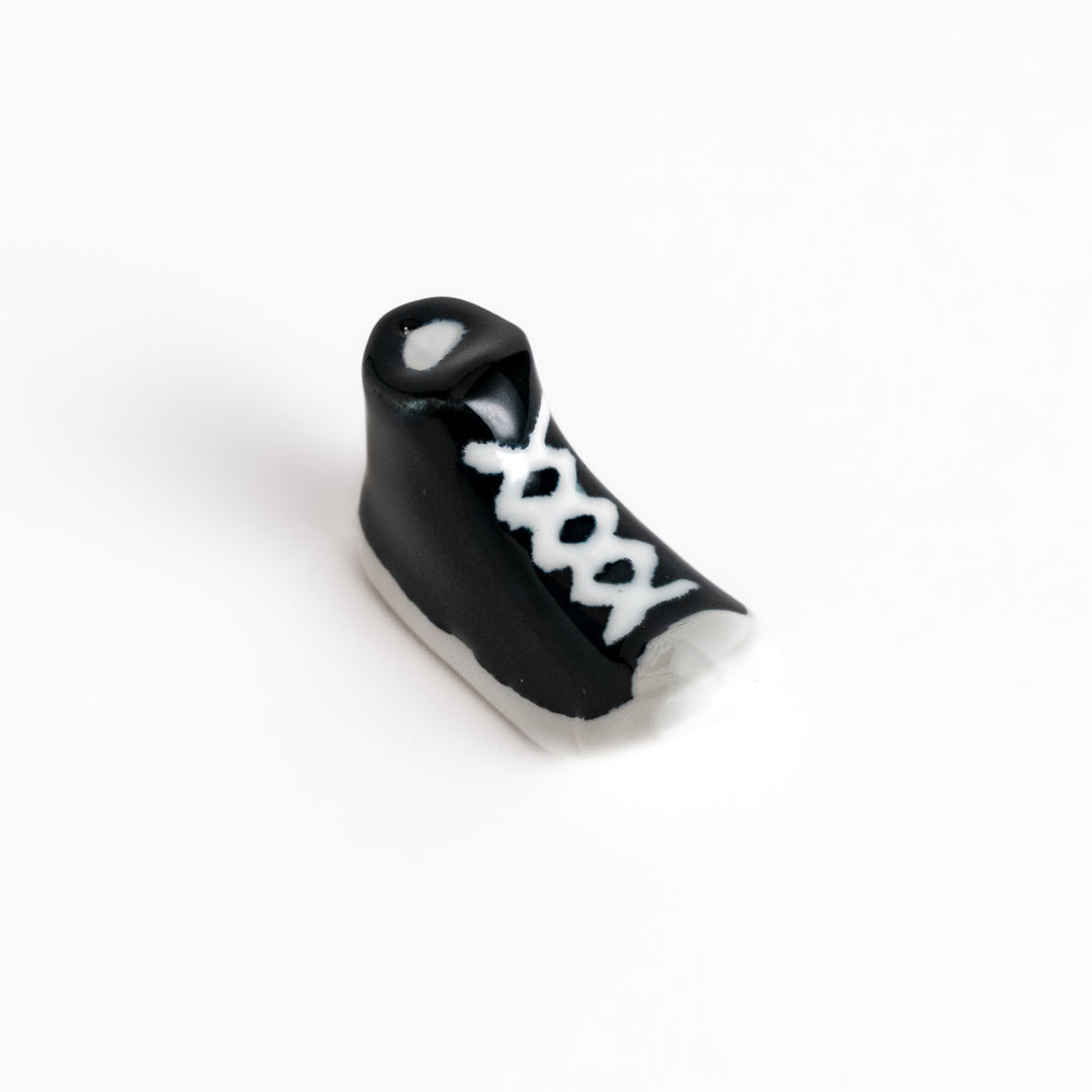 Black Canvas Sneaker Chopstick Rest with white laces and a detailed high-top design, adding a playful touch to your table setting.