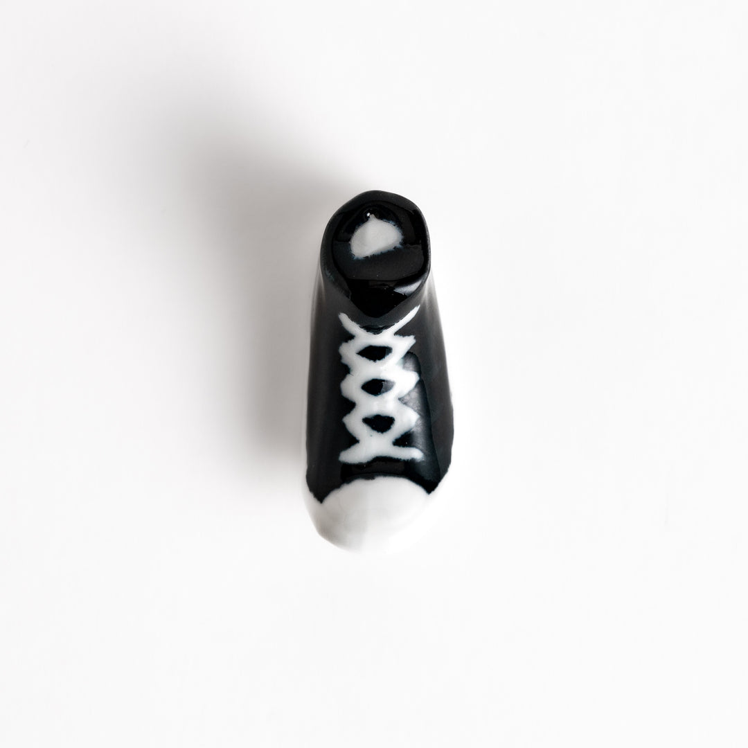 Black Canvas Sneaker Chopstick Rest with white laces and a detailed high-top design, adding a playful touch to your table setting.