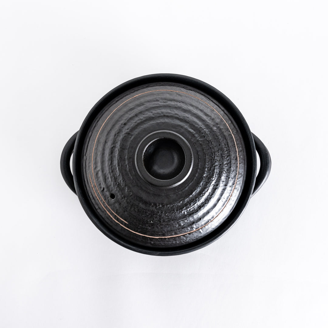 Top-down view of the donabe, highlighting the textured lid and central handle.