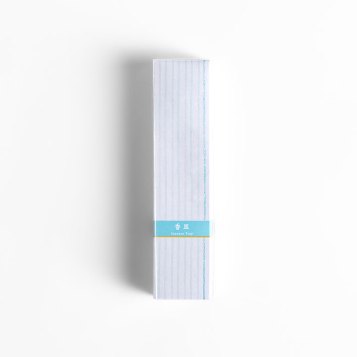 Incense Holder elegantly packaged in a minimalist white box with subtle vertical stripes and a light blue label, designed to complement a serene incense-burning experience.