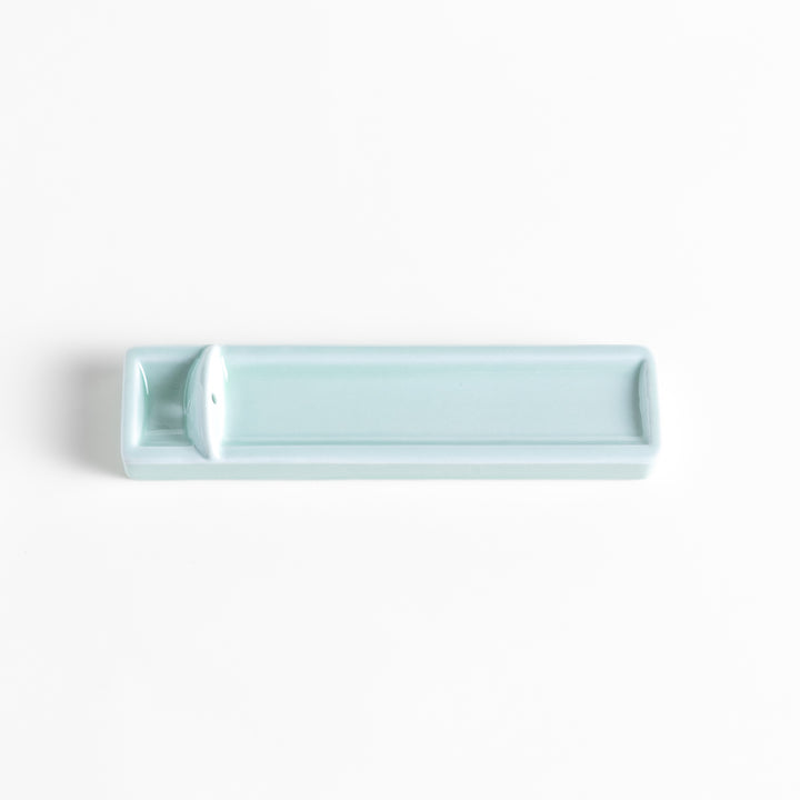 Incense Holder in a sleek celadon ceramic design with a built-in slot for holding sticks, featuring a rectangular shape that elegantly catches falling ash.