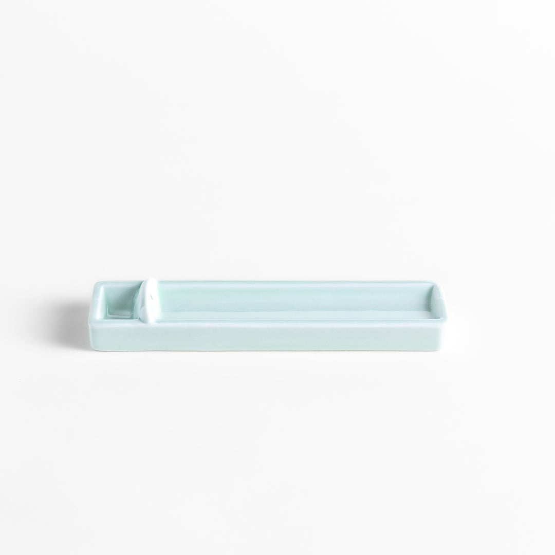 Incense Holder in a sleek celadon ceramic design with a built-in slot for holding sticks, featuring a rectangular shape that elegantly catches falling ash.