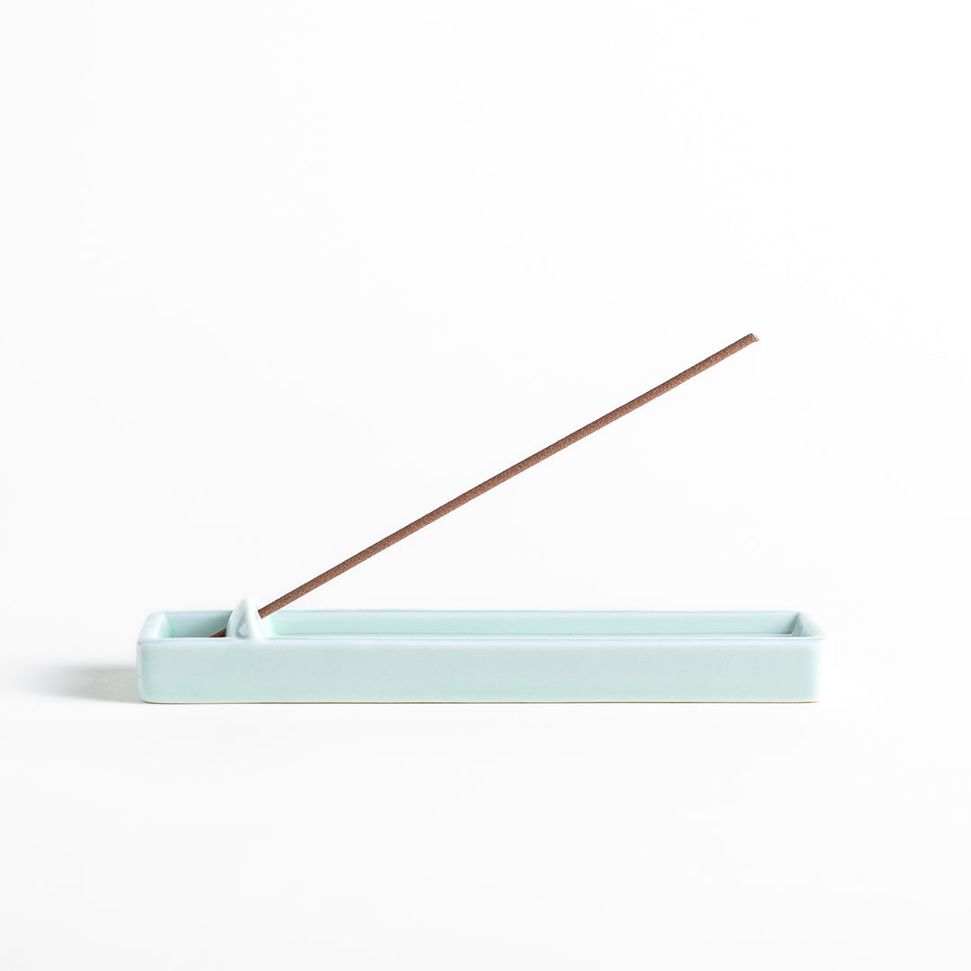 Incense Holder in a sleek celadon ceramic design with a built-in slot for holding sticks, featuring a rectangular shape that elegantly catches falling ash.