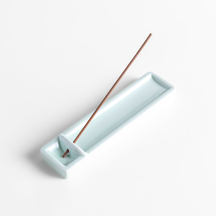 Incense Holder in a sleek celadon ceramic design with a built-in slot for holding sticks, featuring a rectangular shape that elegantly catches falling ash.