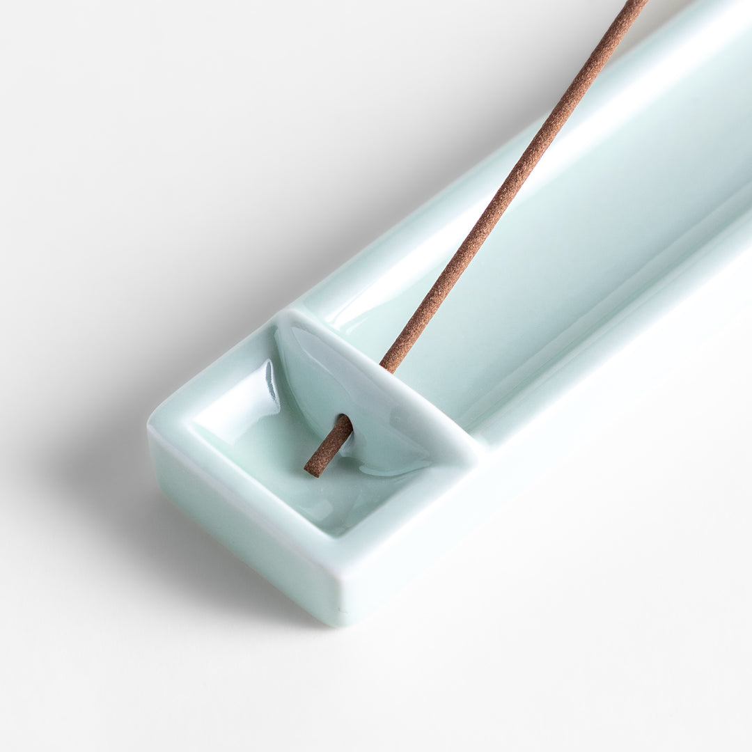 Incense Holder in a sleek celadon ceramic design with a built-in slot for holding sticks, featuring a rectangular shape that elegantly catches falling ash.