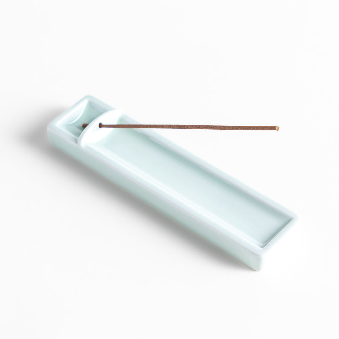 Incense Holder in a sleek celadon ceramic design with a built-in slot for holding sticks, featuring a rectangular shape that elegantly catches falling ash.