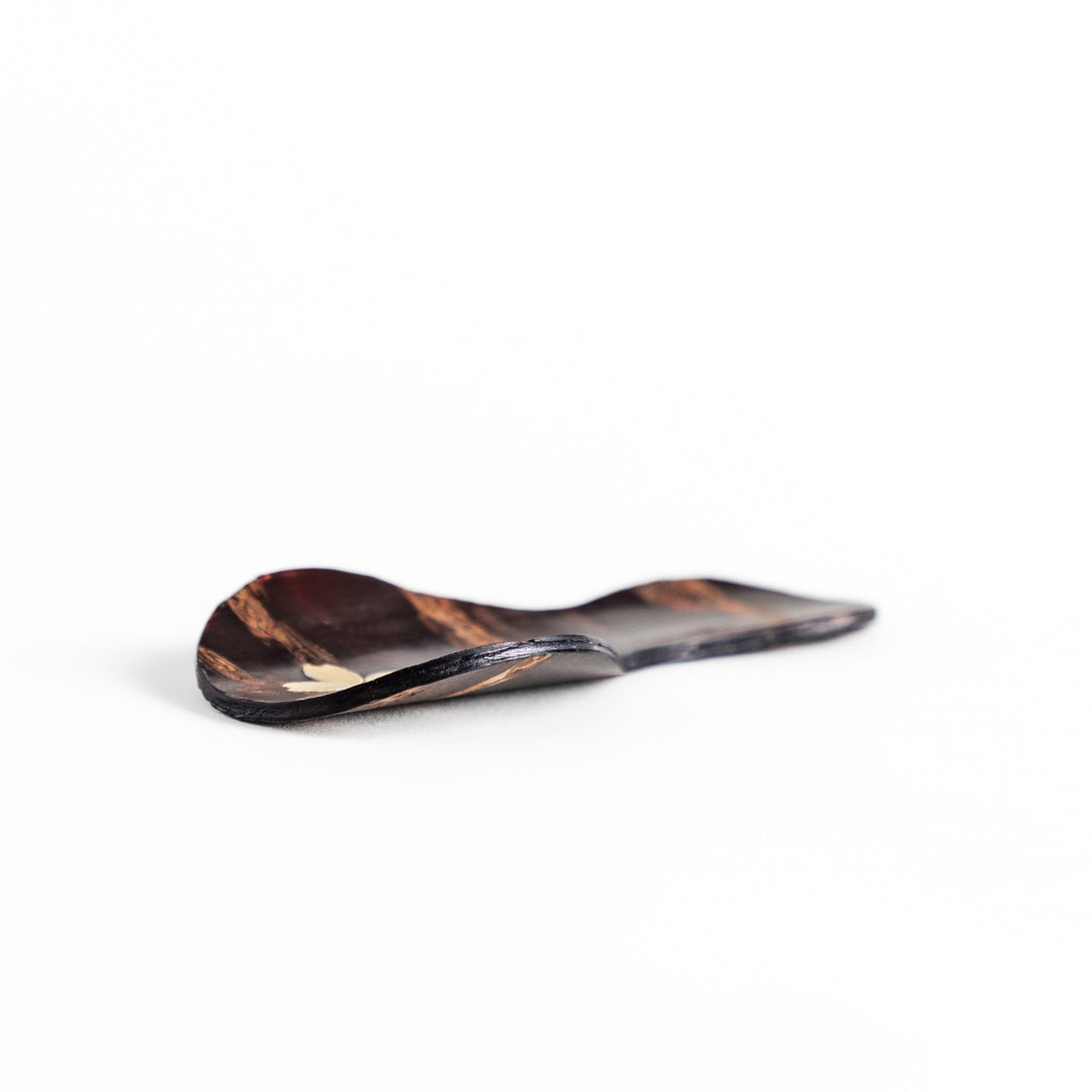 Handcrafted cherry bark tea scoop with a delicate cherry blossom inlay, perfect for measuring loose leaf tea with a touch of traditional elegance.