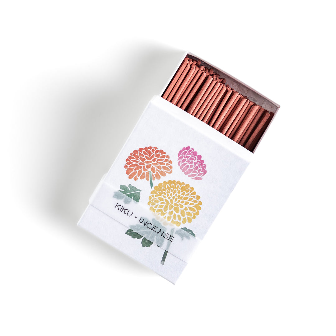 Incense featuring warm reddish-brown sticks in a box decorated with vibrant chrysanthemum flowers, offering a refined floral aroma for a calming atmosphere.