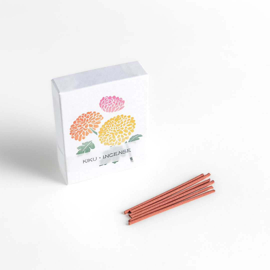 Incense featuring warm reddish-brown sticks in a box decorated with vibrant chrysanthemum flowers, offering a refined floral aroma for a calming atmosphere.