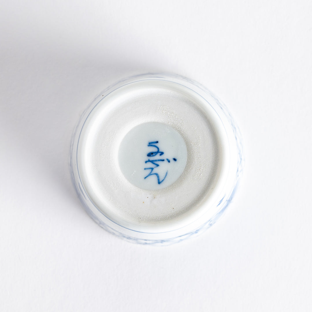 A small white condiment bowl with a delicate blue chrysanthemum and lattice pattern on the exterior.