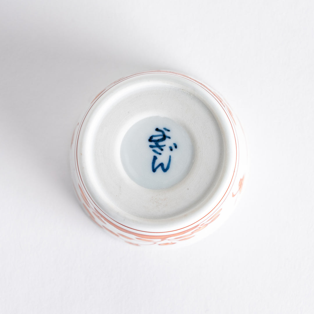 A small white condiment bowl with a delicate blue chrysanthemum and lattice pattern on the exterior.