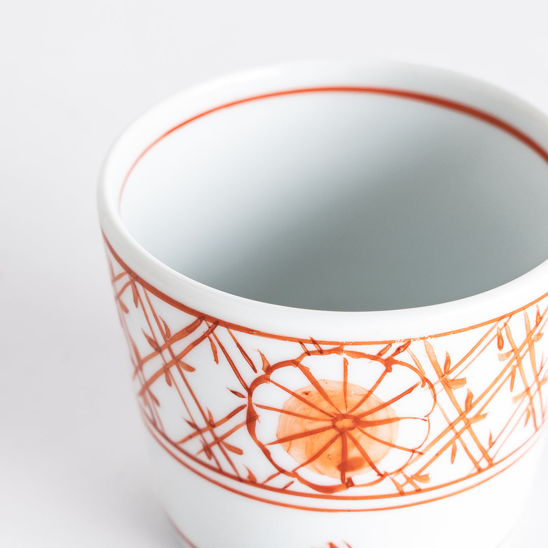 A small white condiment bowl with a delicate blue chrysanthemum and lattice pattern on the exterior.