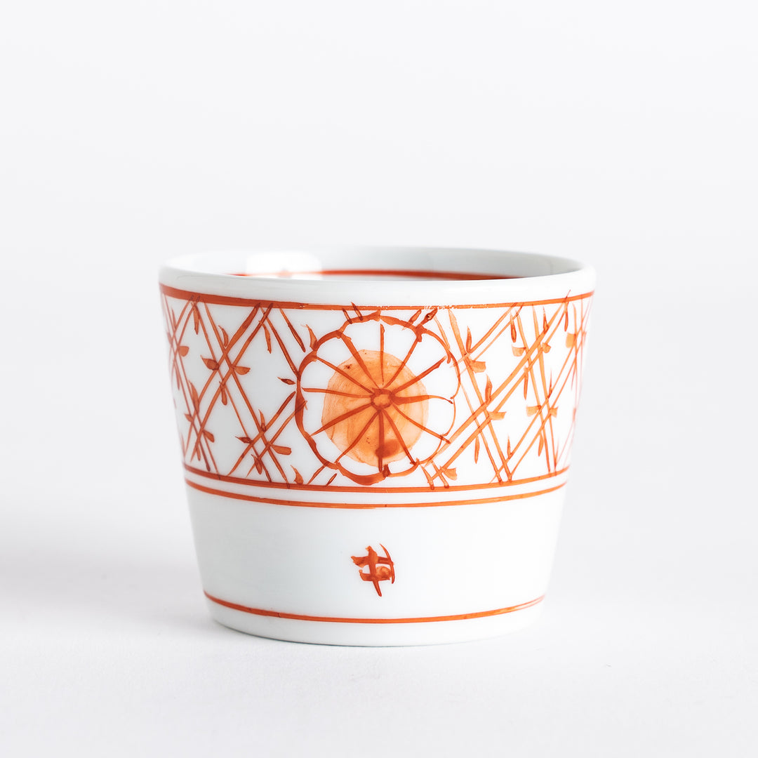 A small white condiment bowl with a delicate blue chrysanthemum and lattice pattern on the exterior.