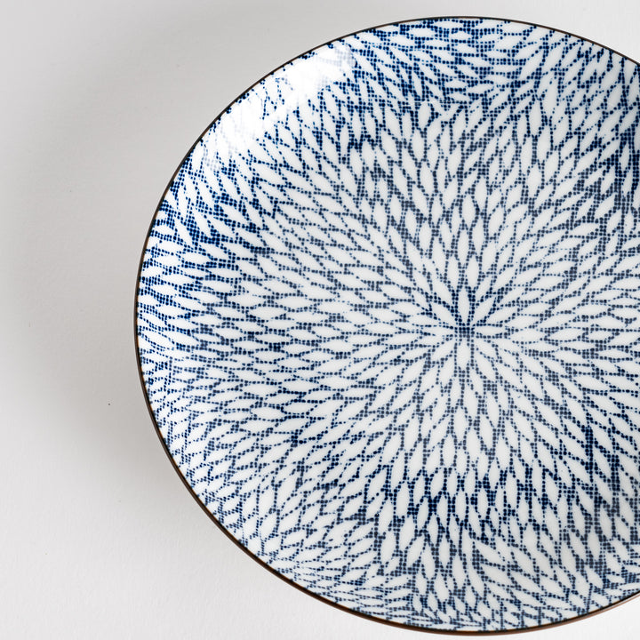 A salad plate with a detailed blue herringbone pattern radiating from the center.