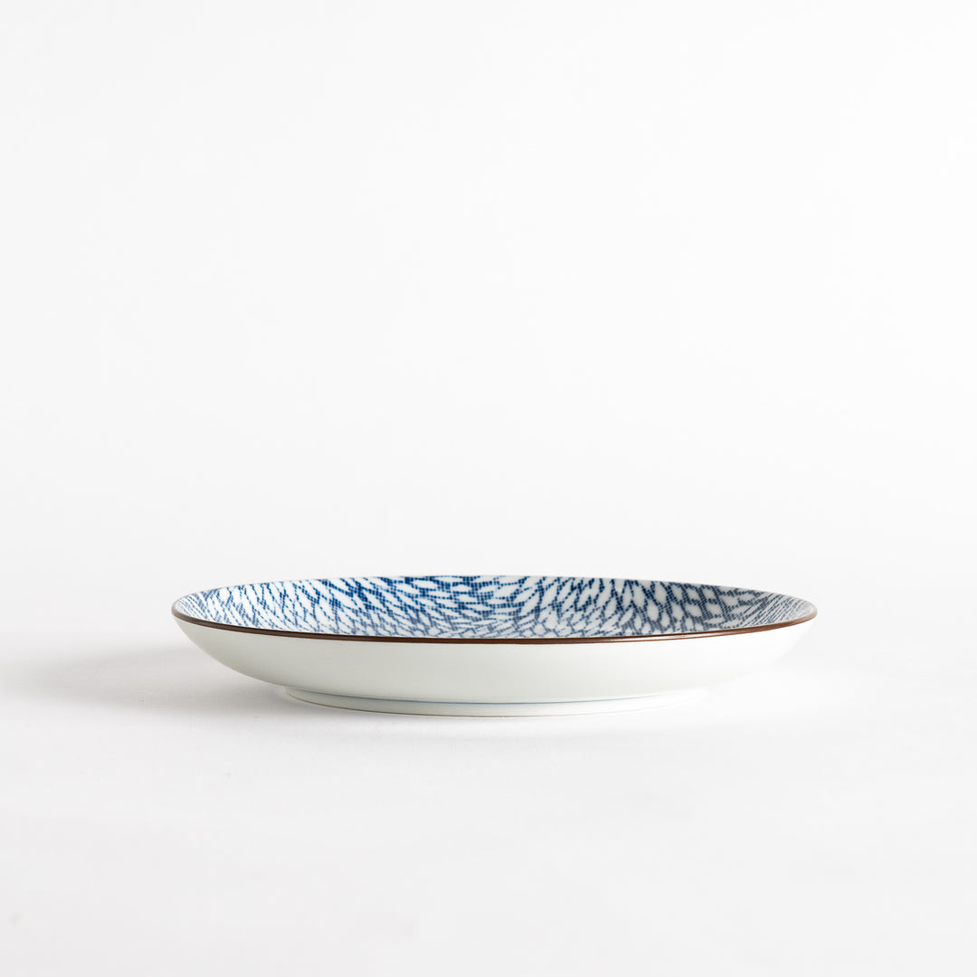 A salad plate with a detailed blue herringbone pattern radiating from the center.