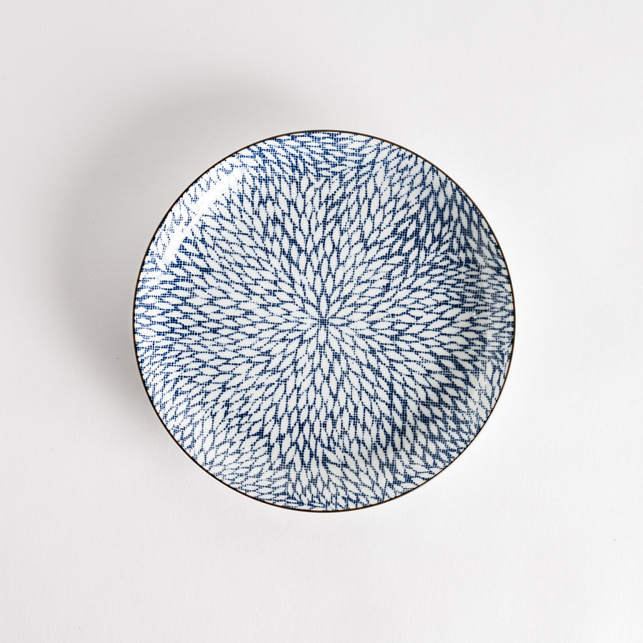 A salad plate with a detailed blue herringbone pattern radiating from the center.