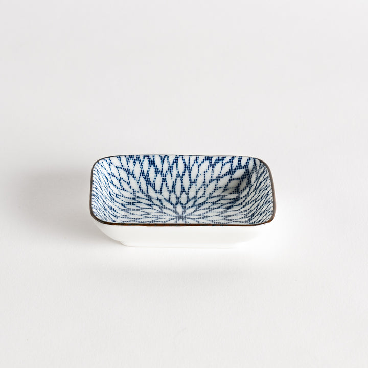 A small rectangular dish featuring a blue herringbone pattern on a white background.