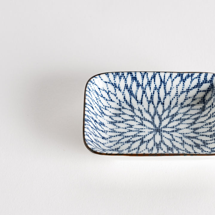 A small rectangular dish featuring a blue herringbone pattern on a white background.