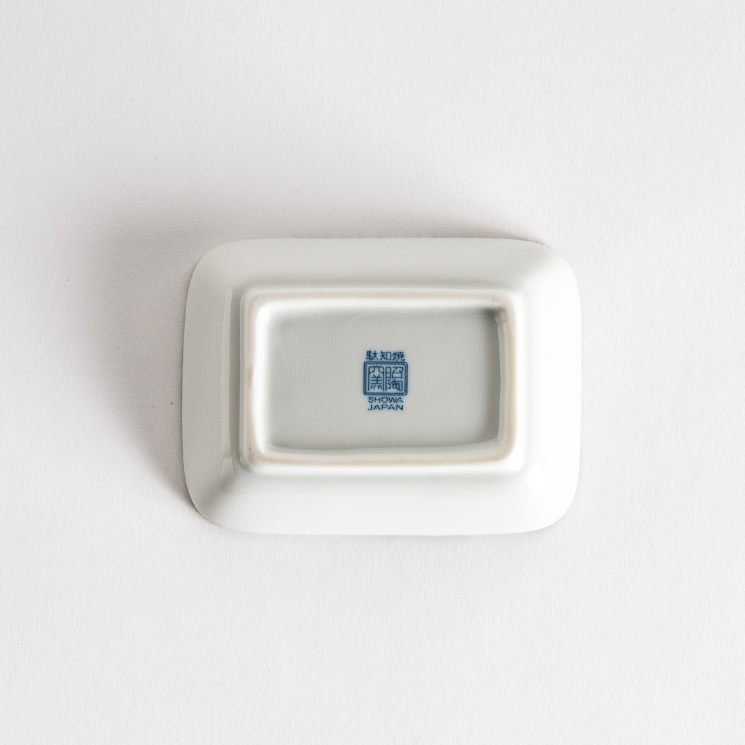 A small rectangular dish featuring a blue herringbone pattern on a white background.