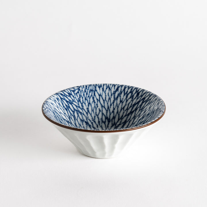 A small fluted bowl with a blue herringbone pattern on a white background.