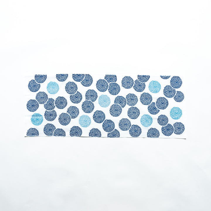 Blue chrysanthemum-patterned tenugui hand towel spread horizontally, showcasing the design.