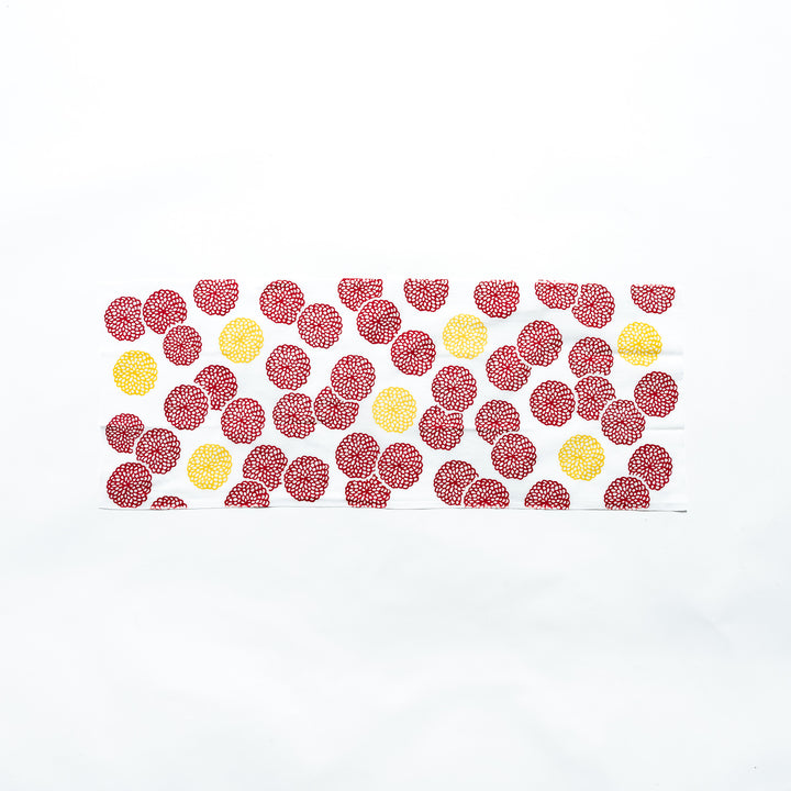 Red and yellow chrysanthemum-patterned tenugui hand towel displayed fully, revealing its colorful design.