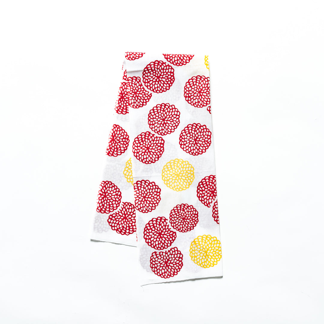 Red and yellow chrysanthemum-patterned tenugui hand towel with vibrant circular designs.