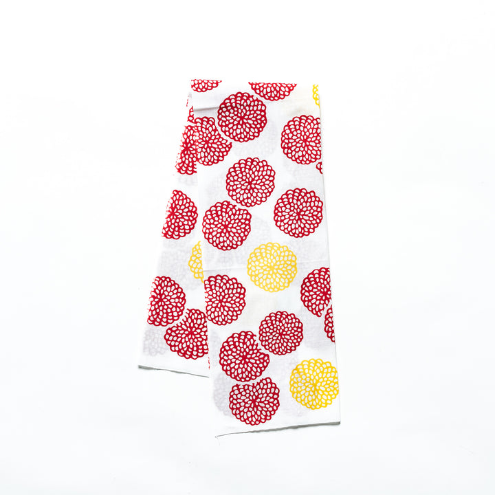 Red and yellow chrysanthemum-patterned tenugui hand towel with vibrant circular designs.