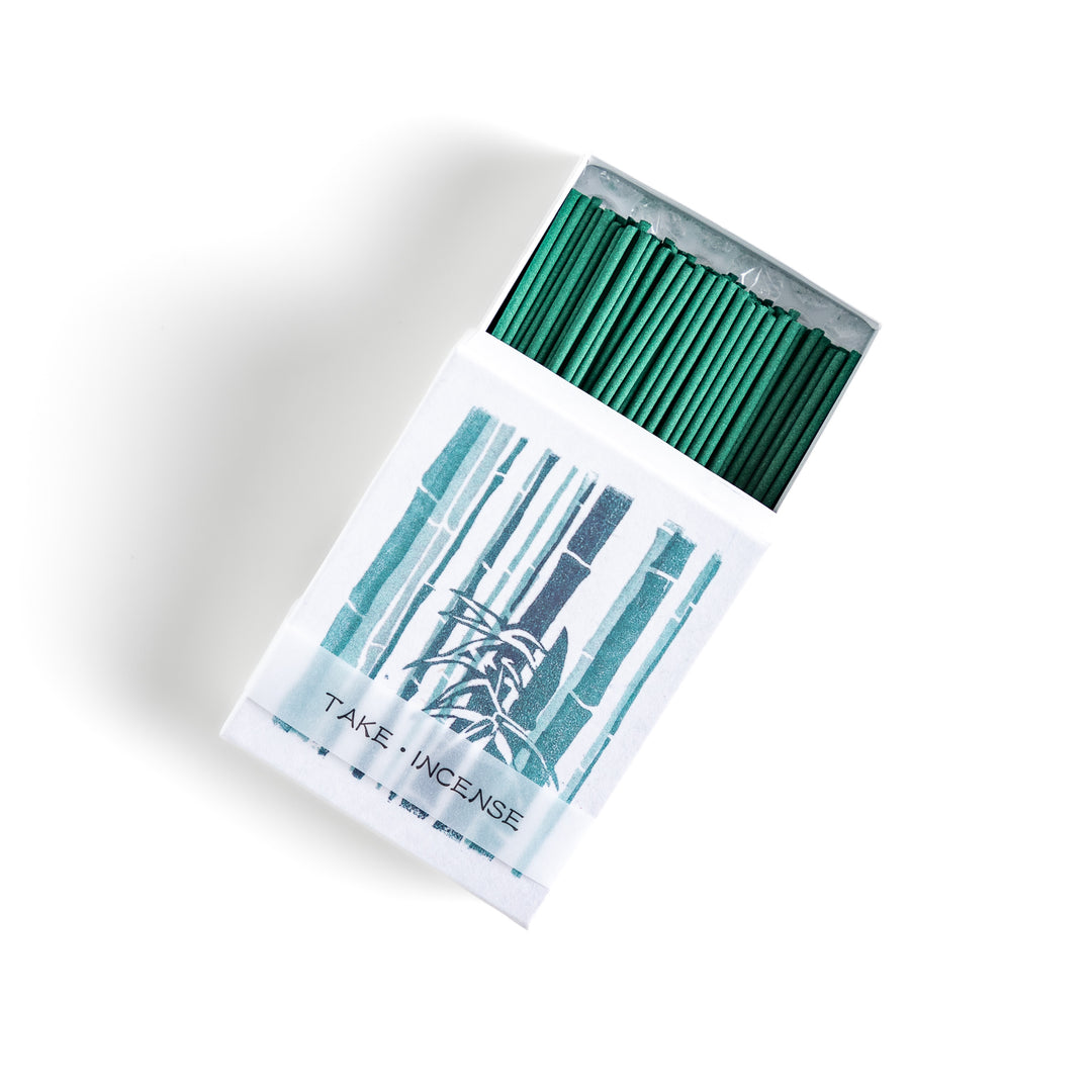 Incense featuring deep green sticks in a box adorned with a traditional Japanese bamboo design, offering a fresh and calming fragrance inspired by nature.